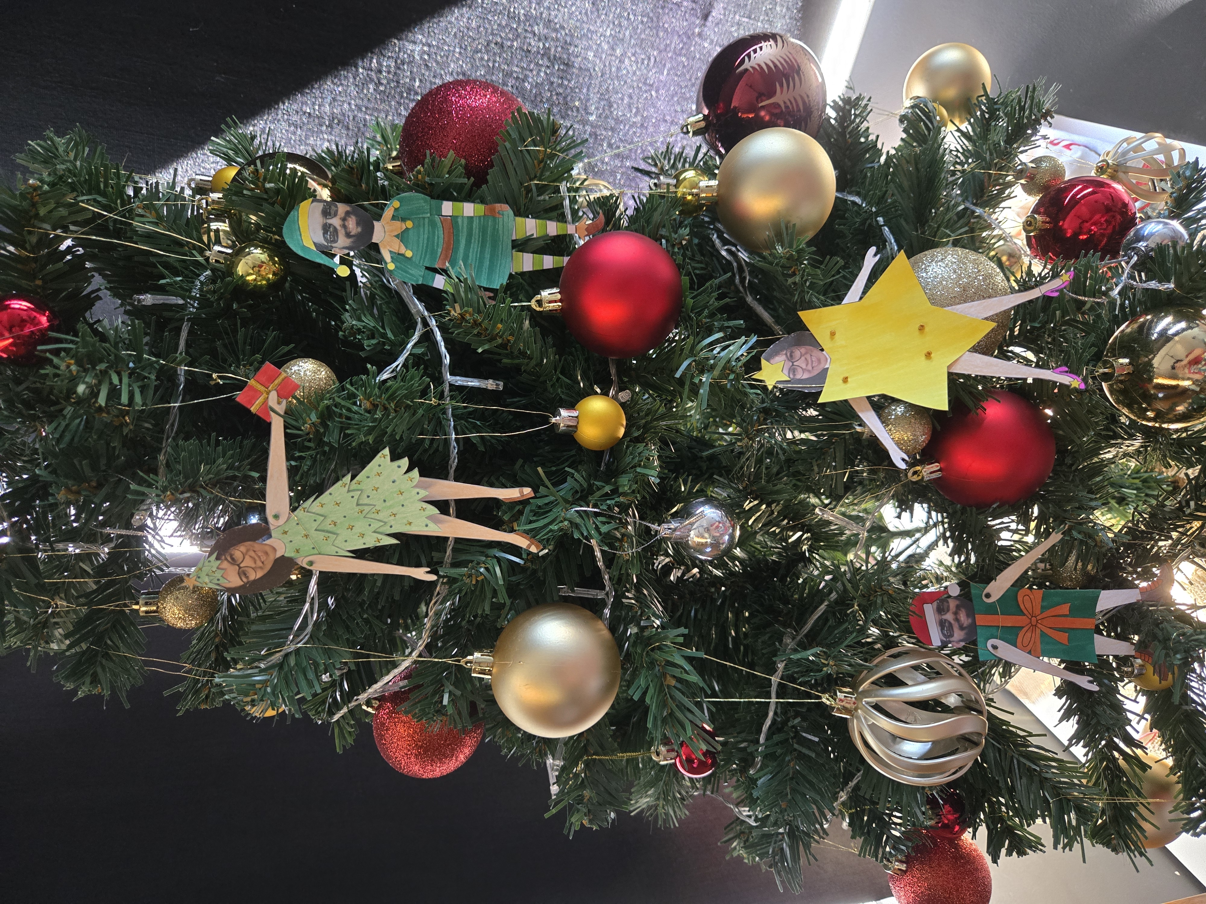 Bonecas de papel penduradas na árvore